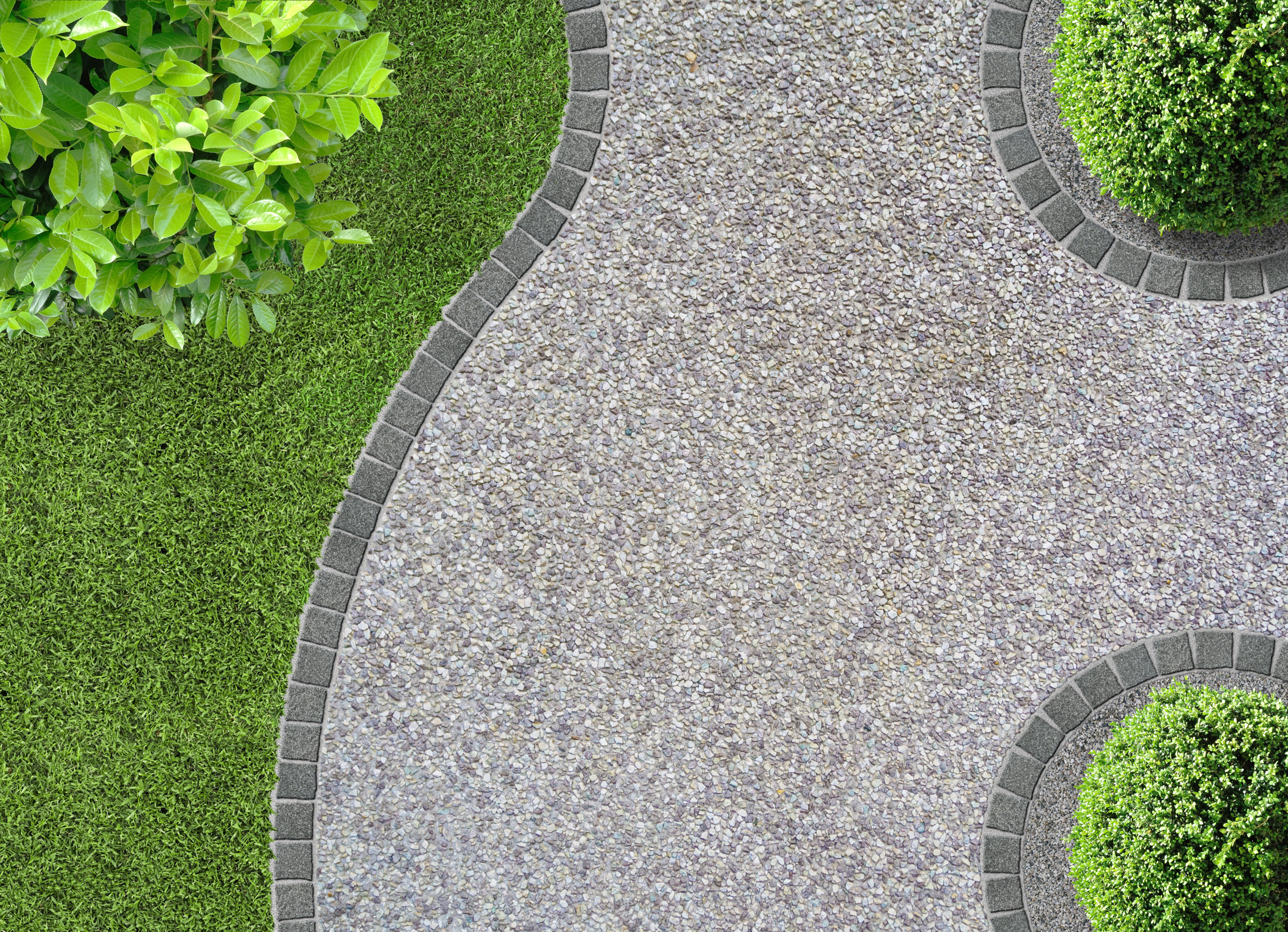 garden with a beautiful pedestrian path made of exposed aggregate concrete 